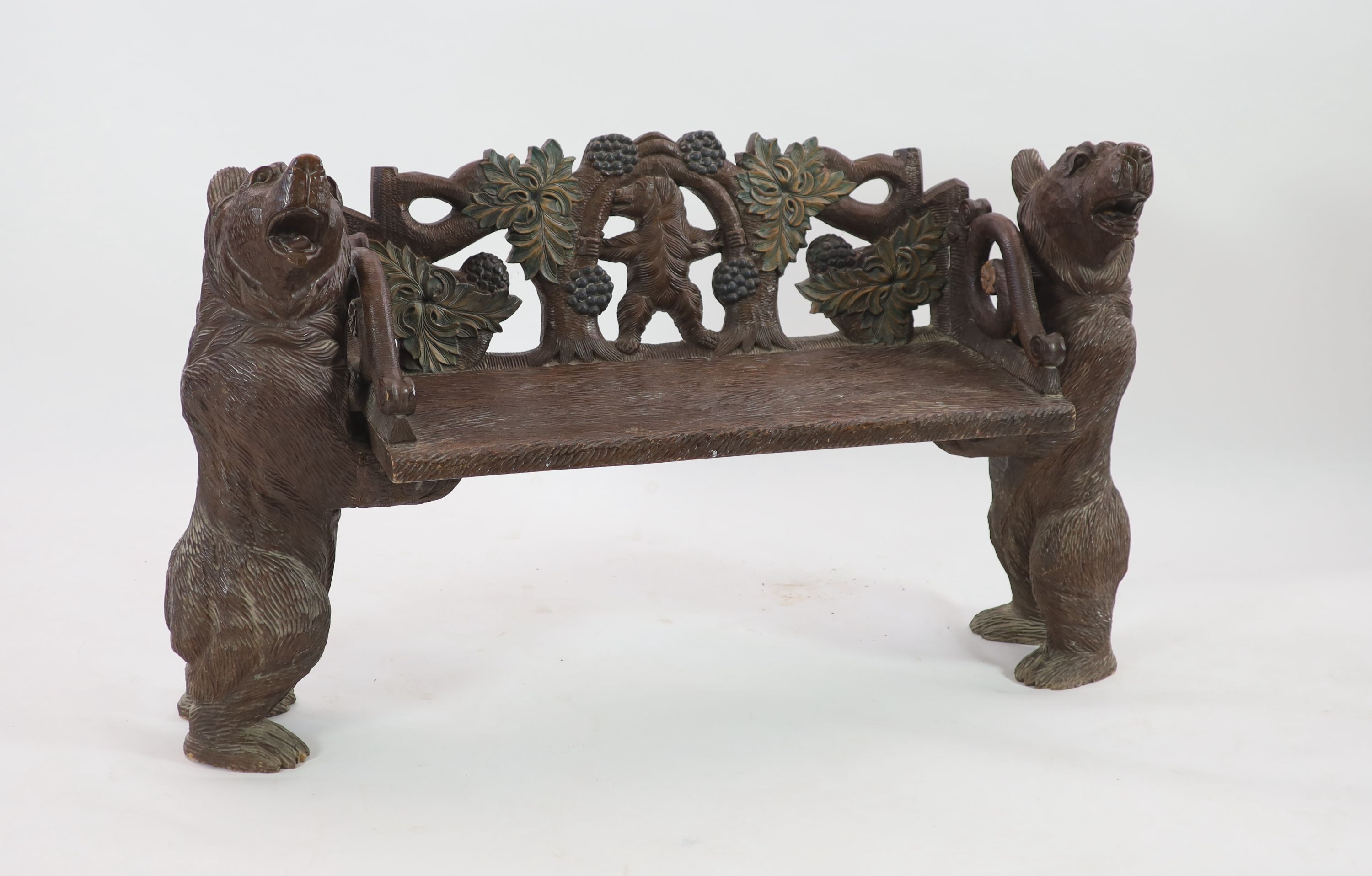 An early 20th century Black Forest carved wood bear hall seat, W.162cm D.52cm H.95cm